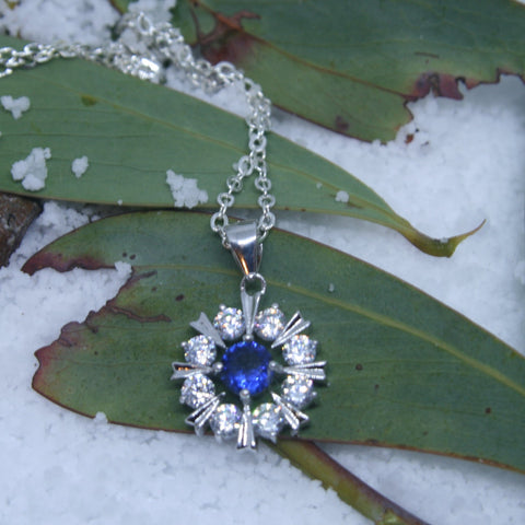 Sterling Silver Snowflake pendant w/- 1 Blue & White CZ's - SXP377